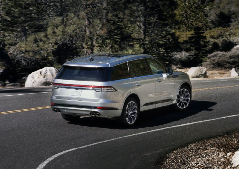 A 2023 Lincoln Aviator® Grand Touring model is shown being driven on a tight turn of a mountain road | Bozard Lincoln in Saint Augustine FL