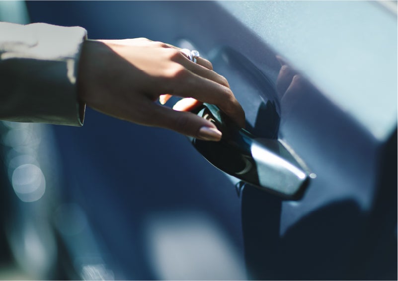 A hand gracefully grips the Light Touch Handle of a 2023 Lincoln Aviator® SUV to demonstrate its ease of use | Bozard Lincoln in Saint Augustine FL
