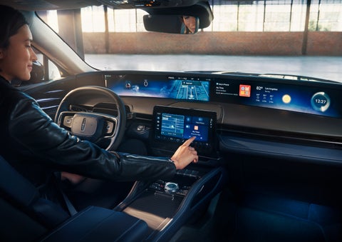 The driver of a 2024 Lincoln Nautilus® SUV interacts with the center touchscreen. | Bozard Lincoln in Saint Augustine FL