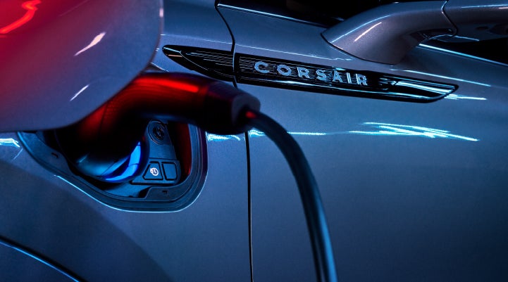 A charger plugged into the charging port of a 2024 Lincoln Corsair® Plug-in Hybrid model. | Bozard Lincoln in Saint Augustine FL