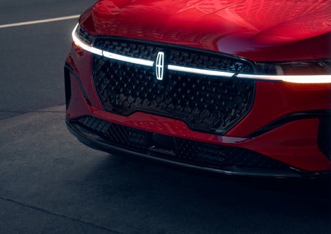 The available front LED light bar and center Lincoln Star logo glow at dusk. | Bozard Lincoln in Saint Augustine FL