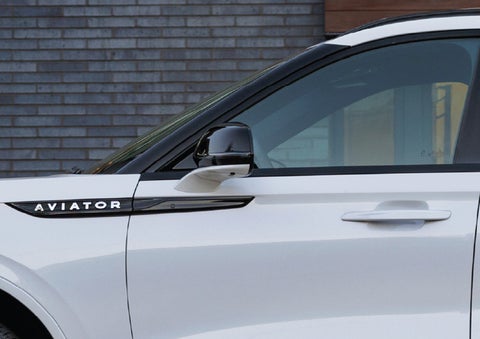 The driver’s side door and fender badging of a white 2026 Lincoln Aviator® SUV are showcased. | Bozard Lincoln in Saint Augustine FL