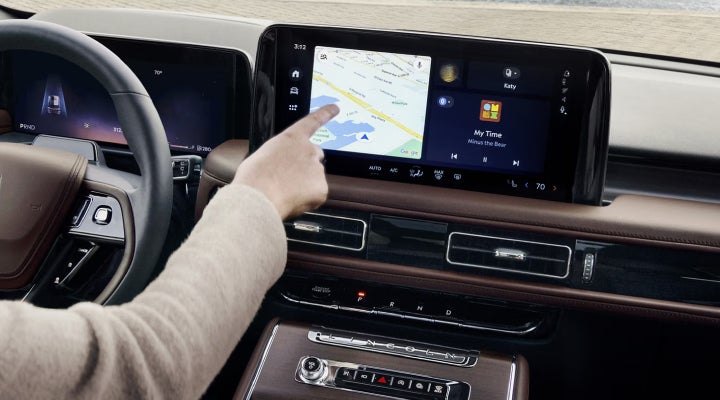 A person is tapping the center display touchscreen of a 2026 Lincoln Aviator® SUV. | Bozard Lincoln in Saint Augustine FL