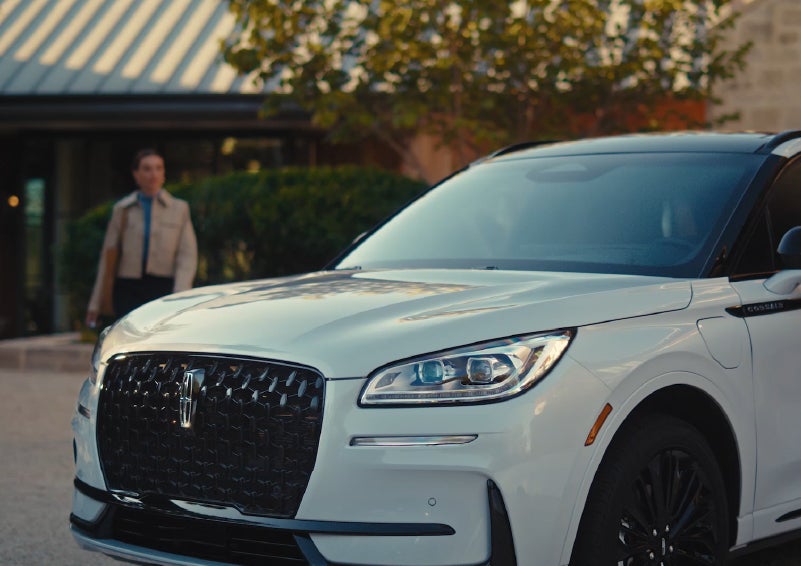 A person approaches a 2026 Lincoln Corsair® SUV as the Lincoln Embrace light sequence takes place. | Bozard Lincoln in Saint Augustine FL