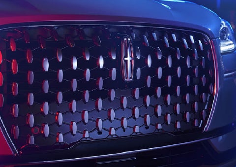 The grille of a 2025 Lincoln Corsair&reg; SUV reflects neon light at night. | Bozard Lincoln in Saint Augustine FL