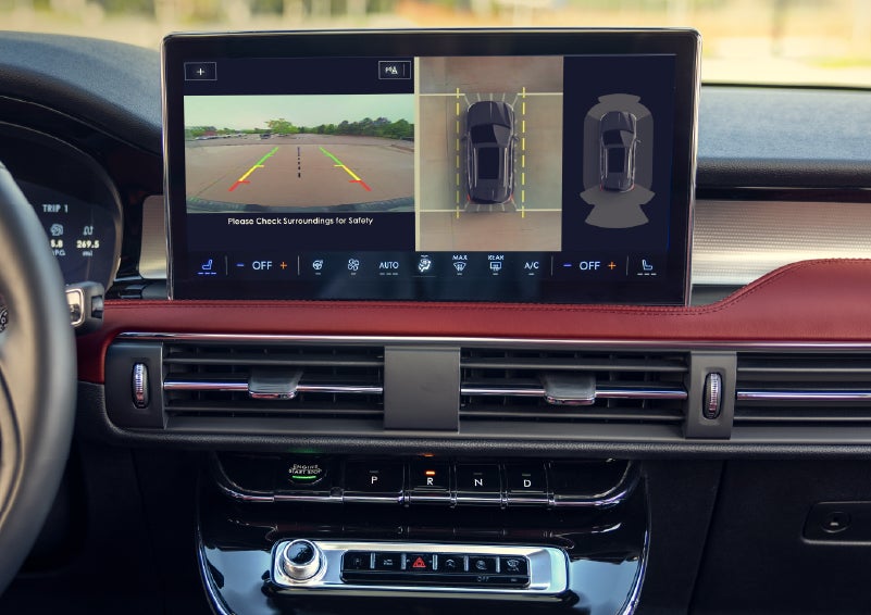 A couple approaches a 2026 Lincoln Corsair® Reserve model as the Lincoln Embrace illumination guides the way | Bozard Lincoln in Saint Augustine FL