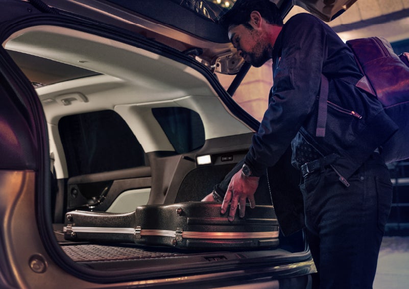 A man is shown loading cargo into the rear of a 2026 Lincoln Corsair® SUV with the second-row seats folded flat. | Bozard Lincoln in Saint Augustine FL