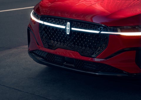 The available front LED light bar and center Lincoln Star logo glow at dusk. | Bozard Lincoln in Saint Augustine FL