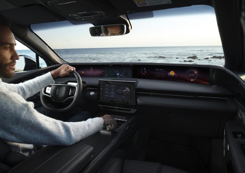 A driver of a parked 2026 Lincoln Nautilus® SUV takes a relaxing moment at a seaside overlook while inside his Nautilus. | Bozard Lincoln in Saint Augustine FL