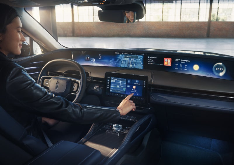 The driver of a 2026 Lincoln Nautilus® SUV interacts with the center touchscreen. | Bozard Lincoln in Saint Augustine FL