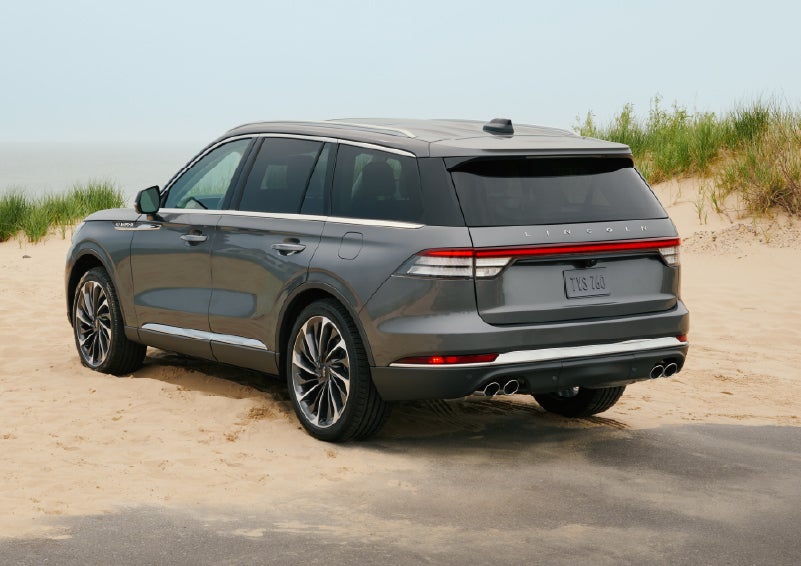 A 2027 Lincoln Aviator® SUV is parked next to sand dunes. | Bozard Lincoln in Saint Augustine FL