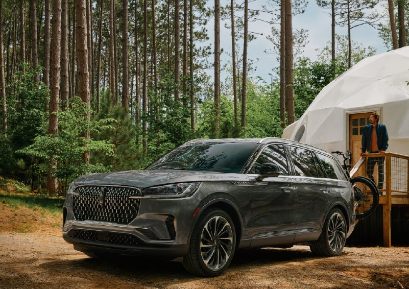 A 2027 Lincoln Aviator® is parked next to a high end glamping site. | Bozard Lincoln in Saint Augustine FL