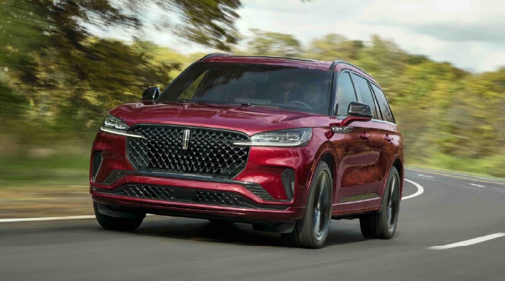 A 2027 Lincoln Aviator® SUV is being driven on a country road | Bozard Lincoln in Saint Augustine FL