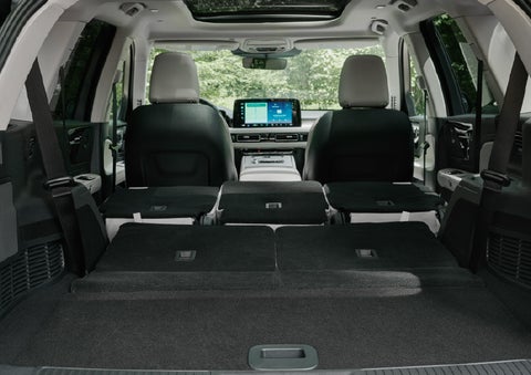 A rear to front view of the interior of a 2027 Lincoln Aviator® Black Label™ SUV shows the third and second rows folded flat | Bozard Lincoln in Saint Augustine FL