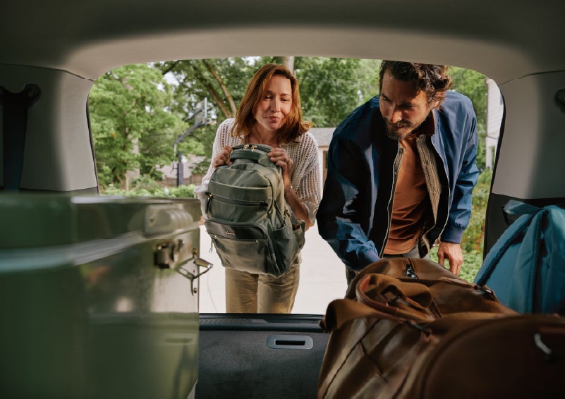 A couple loads luggage into the rear of a 2027 Lincoln Aviator® Black Label™ SUV..e 202 | Bozard Lincoln in Saint Augustine FL