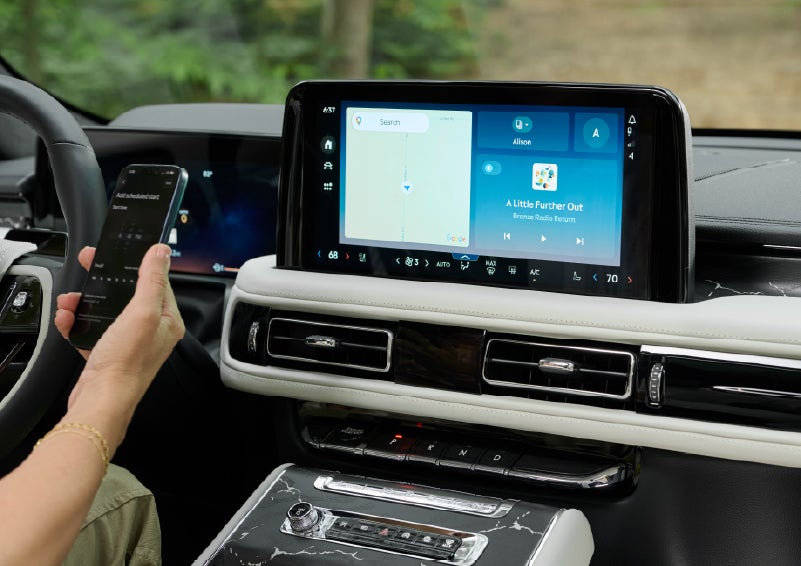 A person pairs thier phone with the center touchscreen of a 2027 Lincoln Aviator® Black Label™ SUV | Bozard Lincoln in Saint Augustine FL